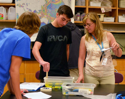 Sandie Cecelski helps a couple of her students in the Marine Science Academy at Ashley High School with their hands-on bathymetry classroom exercise. Photo: Tess Malijenovsky