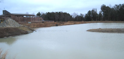 This draining of this stormwater pond in January led to the state investigation. The Methodist church construction site is visible on the left. Photo: Frank Tursi