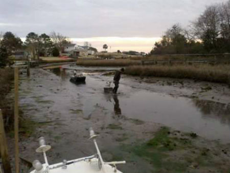 Eddie Privette now has to lug his oysters across the mud to his dock on Hawkins Creek. Photo: Brad Rich