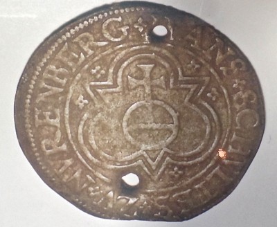 Among its findings on Hatteras Island, CAS uncovered a Nuremburg Token, which is a round metal piece resembling a coin, and which was used with other such coins to aid in counting, like a modern day calculator. It is identical to three tokens found on Roanoke Island, which the society said can only be explained in terms of Elizabethan colonization ventures. Photo: Ed Beckley