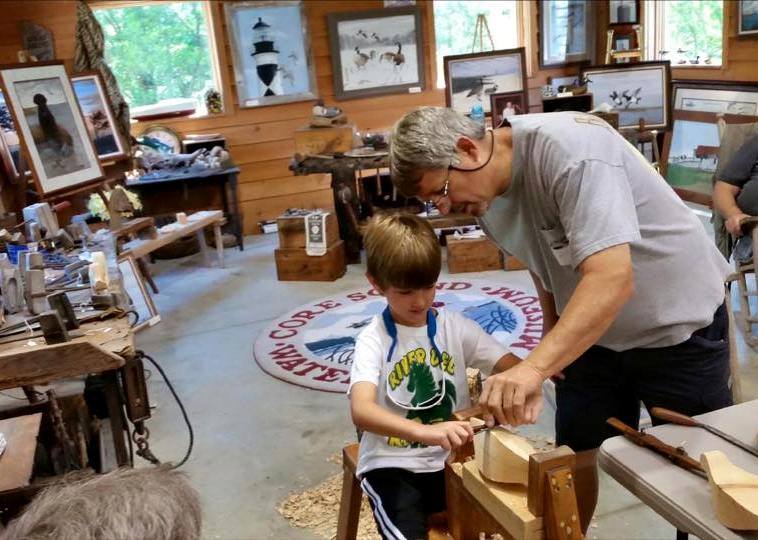Waterfowl carvers demonstrate techniques of carving functional decoys as part of the summer program.