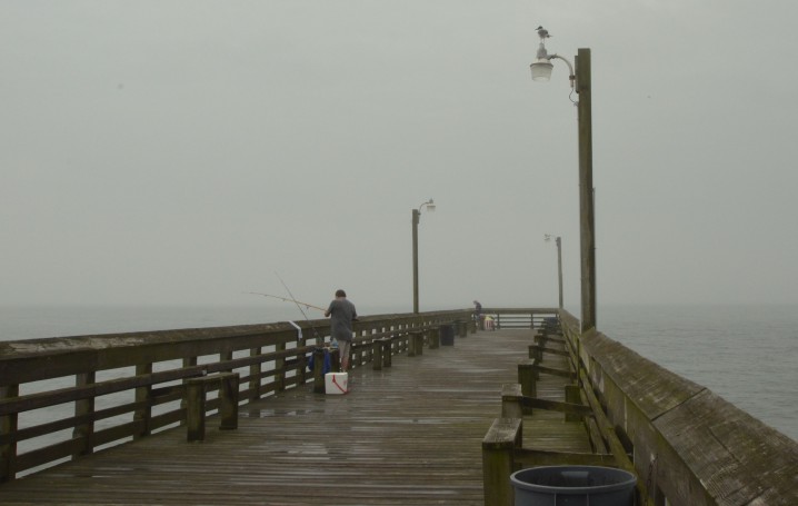 Pat Moss of High Point came to fish on the Holden Beach Pier on a rainy morning. “I don’t have a problem with it [offshore drilling] as long as it’s regulated," he said. "Then again, the oil companies have the regulators in their pockets.” Photo: Tess Malijenovsky