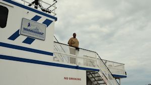 Chris Pittman keeps a lookout, working on the Southport ferry. He says offshore drilling would boost the local economy and bring more maritime jobs.  Photo by Tess Malenjovsky