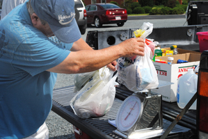 Bill Hadesty, a retired accountant, does a lot of the weighing at Holden Beach. Photo: Hannah Miller