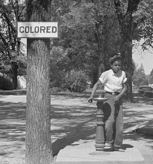 A segregation sign can be seen next to a drinking fountain on the county courthouse lawn in Halifax, N.C. Photographed by John Vachon, April 1938. Courtesy of the Prints and Photographs Division, Library of Congress, Washington, D.C.