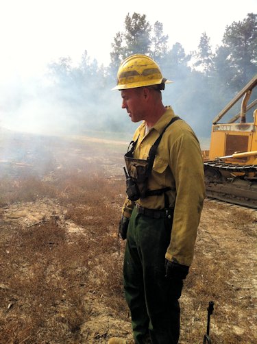 Kenneth Shugart works a fire at a game lands in Bladen County to restore a longleaf pine forest. Photo: Allison Ballard