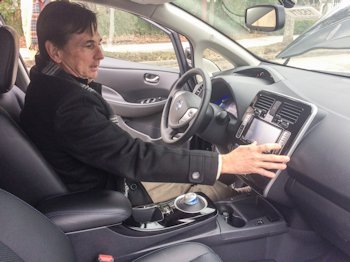 Kent Perry of Greenville Nissan demonstrates the controls of a Nissan LEAF for meeting attendees in New Bern. Photo: Mark Hibbs