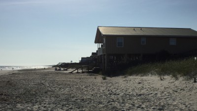 Holden Beach is considering building a terminal groin to protect homes, including this house at the end of McCray Street on the eastern end of the Brunswick County barrier island. Chronic erosion at the eastern end of the island has claimed numerous homes over the decades. Photo: Trista Ralton
