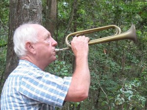 Gene Huntsman uses a bugle as a signal for others building the Neusiok Trail. Photo: Carteret County Wildlife Clun