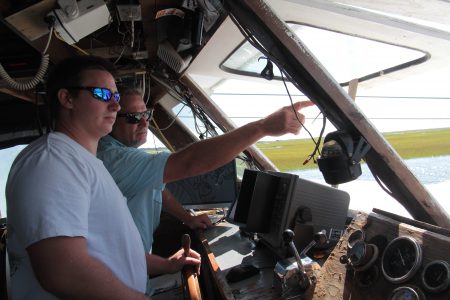 Jefferey Frye, left, of Millis Seafood and Bill Davis of Davis Seafood try to find a route through the heavily shoaled New River. Photo: Kirk Ross
