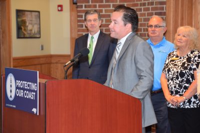 Atlantic Beach Mayor Trace Cooper introduces Gov. Roy Cooper, left, Thursday at Fort Macon State Park. Photo: Mark Hibbs