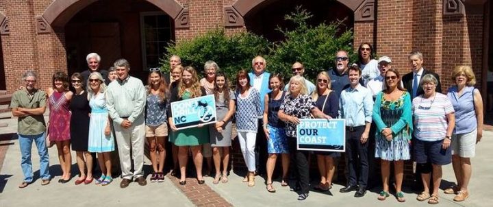 Members of the Save Our Sea group and other environmental advocates pose at Fort Macon State Park where Gov. Roy Cooper recently announced his opposition to offshore drilling and seismic testing. Photo: Contributed